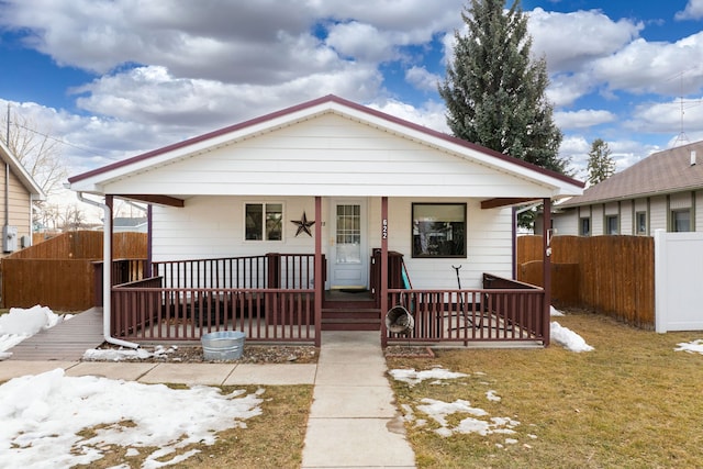 bungalow with a porch and fence