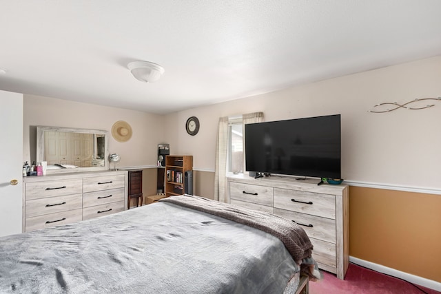 bedroom with carpet flooring and baseboards