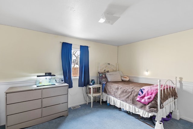 carpeted bedroom featuring visible vents and baseboards