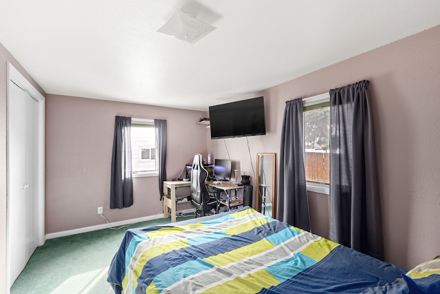 bedroom with carpet floors and baseboards