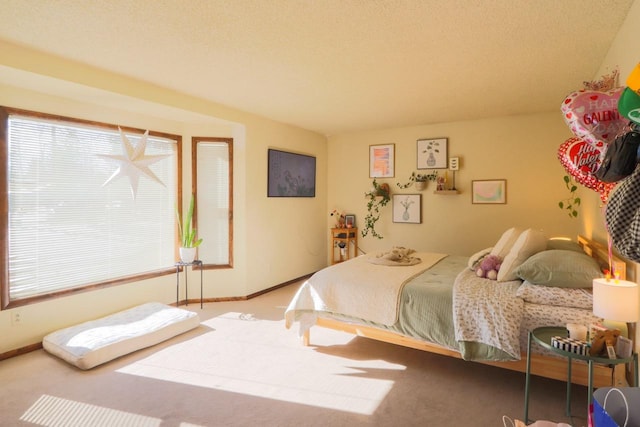 bedroom with carpet floors and baseboards