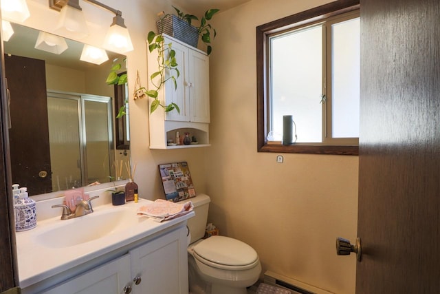 bathroom featuring toilet, a stall shower, and vanity
