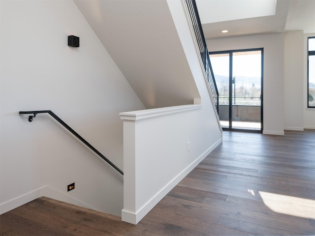 hall featuring recessed lighting, baseboards, an upstairs landing, and wood finished floors