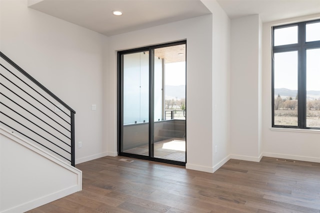 doorway to outside with stairs, wood finished floors, and baseboards