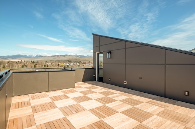 view of patio with a balcony and a mountain view