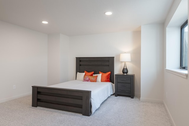 bedroom featuring recessed lighting, light carpet, and baseboards