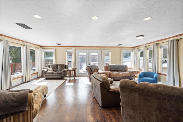 living room with recessed lighting, ornamental molding, dark wood-type flooring, and french doors