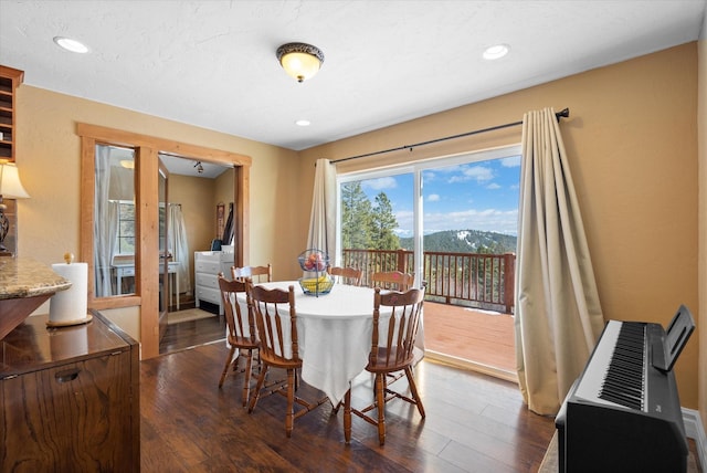 dining room with recessed lighting and dark wood-style flooring