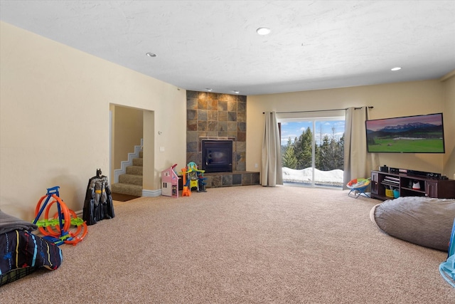 living area featuring carpet floors, recessed lighting, stairway, and a textured ceiling