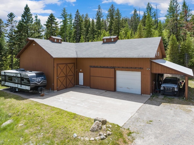 view of front of home with a garage, driveway, and a front lawn