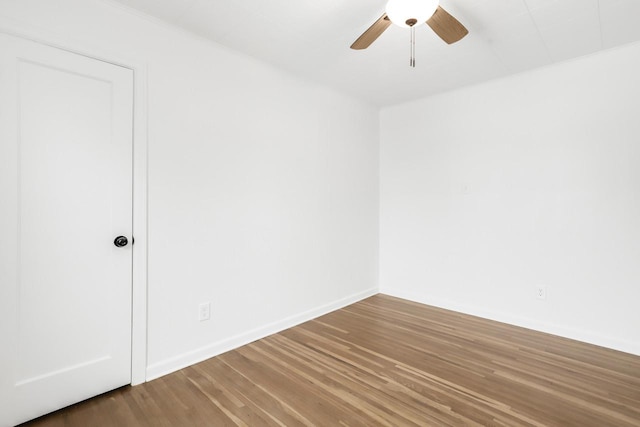 spare room featuring a ceiling fan, baseboards, and wood finished floors