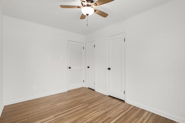 unfurnished bedroom featuring light wood-style floors, ceiling fan, and baseboards