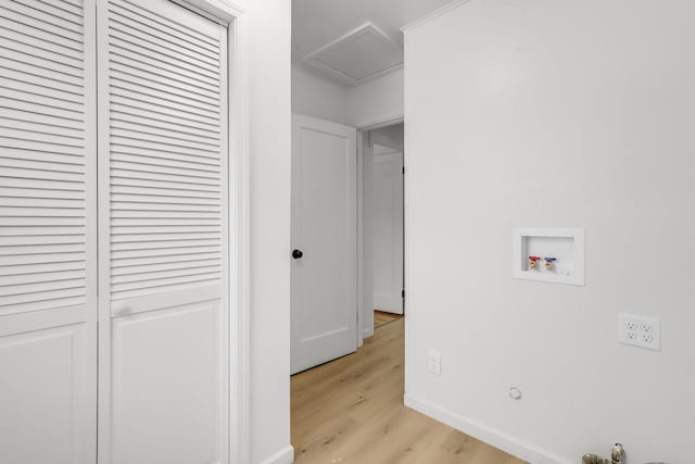 washroom with light wood finished floors, attic access, laundry area, baseboards, and washer hookup