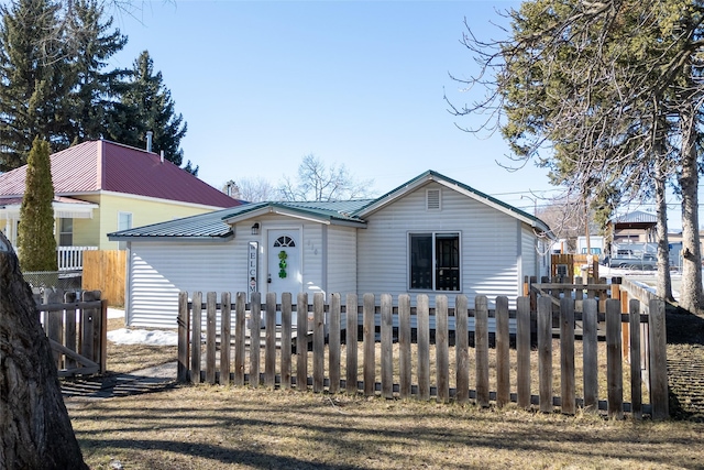 view of front of house with a fenced front yard and metal roof