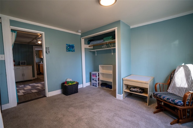 sitting room featuring carpet flooring and baseboards