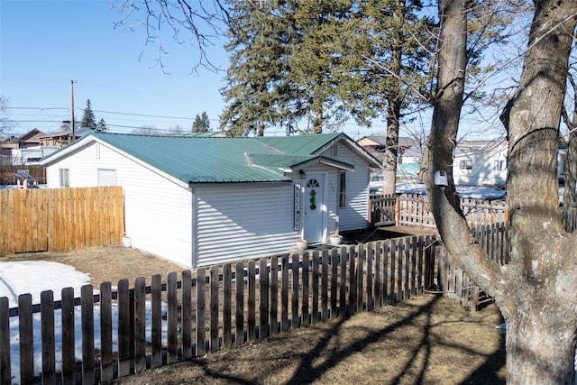 110 10th Ave W, Kalispell, MT 59901 - view of front facade with a metal roof and a fenced backyard