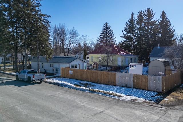 110 10th Ave W, Kalispell, MT 59901 - view of front of house with a fenced front yard, a shed, and a residential view