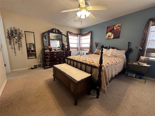 bedroom with light carpet, ceiling fan, a textured ceiling, and baseboards