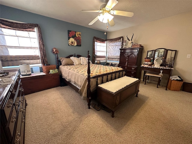 bedroom with a ceiling fan and light carpet