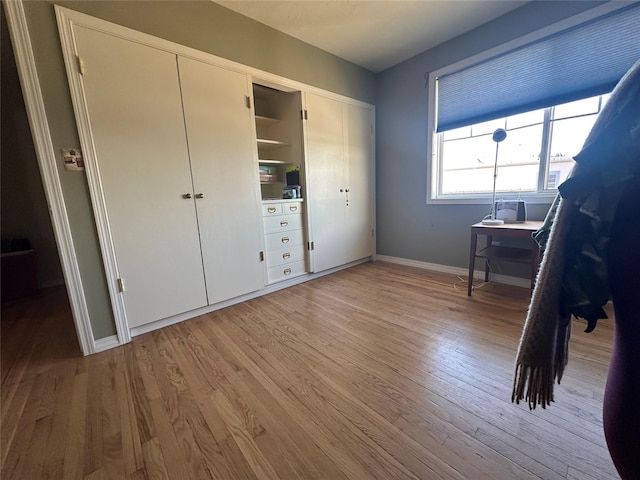 unfurnished bedroom with wood finished floors and baseboards