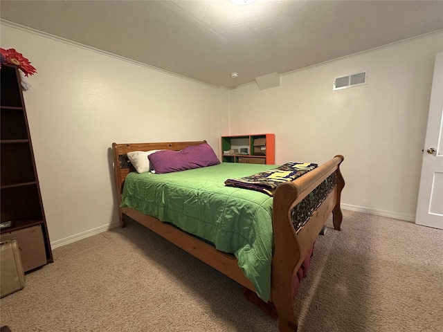 carpeted bedroom featuring baseboards and visible vents