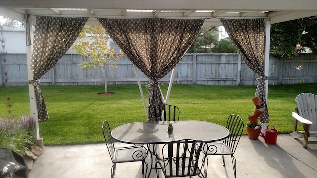 view of patio with a fenced backyard, a pergola, and outdoor dining space