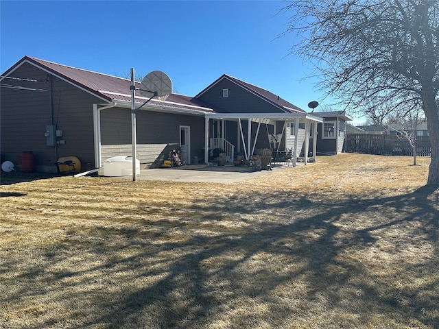 rear view of house with a patio area and fence