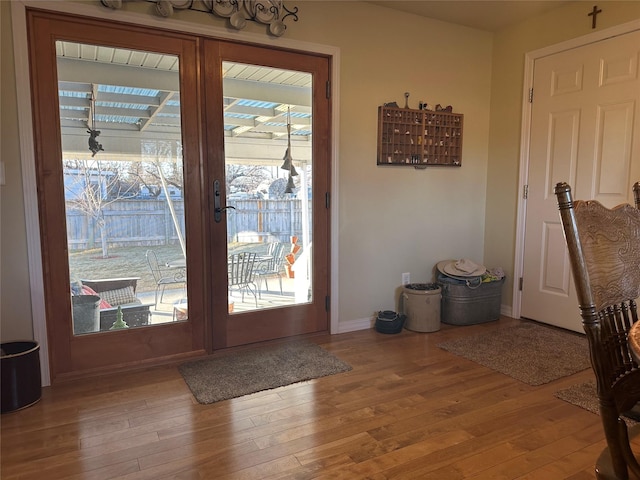 entryway with hardwood / wood-style flooring, baseboards, and french doors