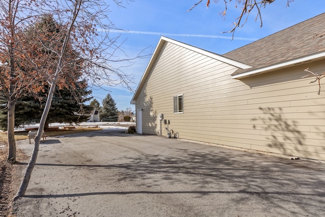 view of home's exterior featuring a shingled roof