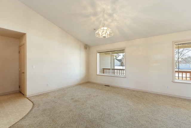 unfurnished room with visible vents, baseboards, vaulted ceiling, and a notable chandelier