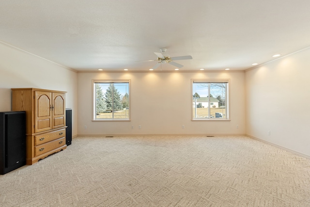 interior space with ornamental molding, recessed lighting, light carpet, and baseboards