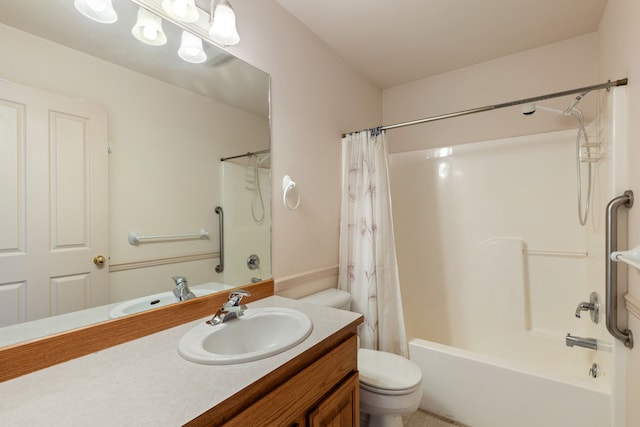 bathroom featuring toilet, shower / bath combo with shower curtain, and vanity