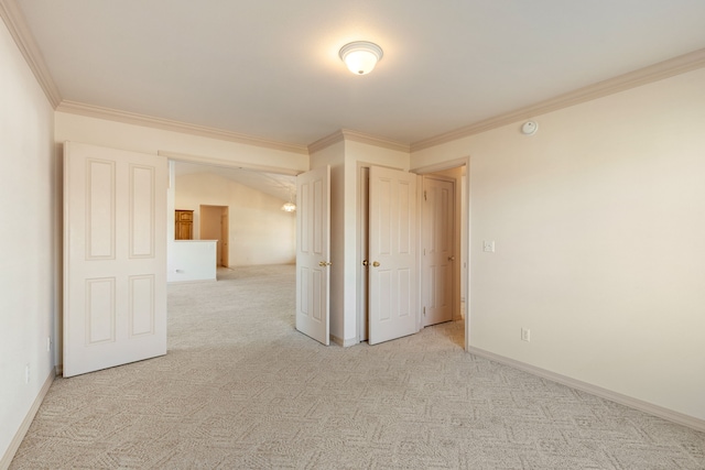 unfurnished bedroom with ornamental molding, carpet flooring, and baseboards