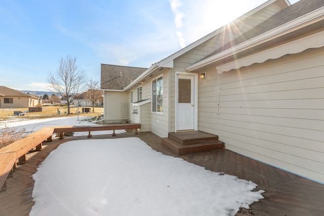 exterior space featuring roof with shingles