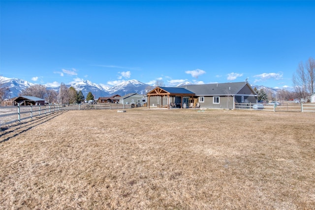 view of yard featuring fence, a mountain view, and a gazebo