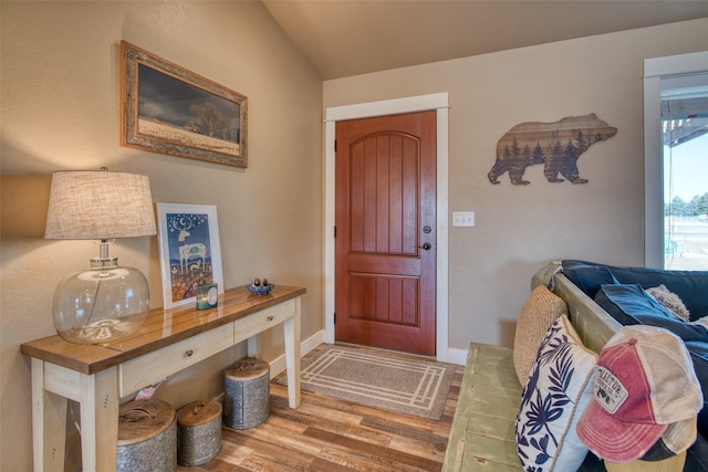 foyer entrance featuring wood finished floors and baseboards