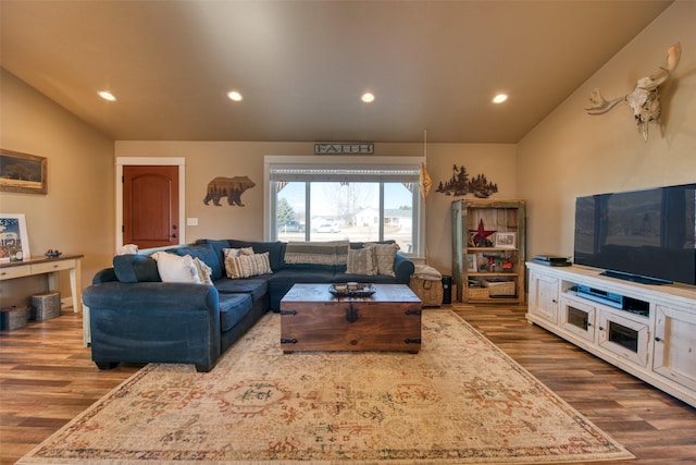 living room with lofted ceiling, wood finished floors, and recessed lighting