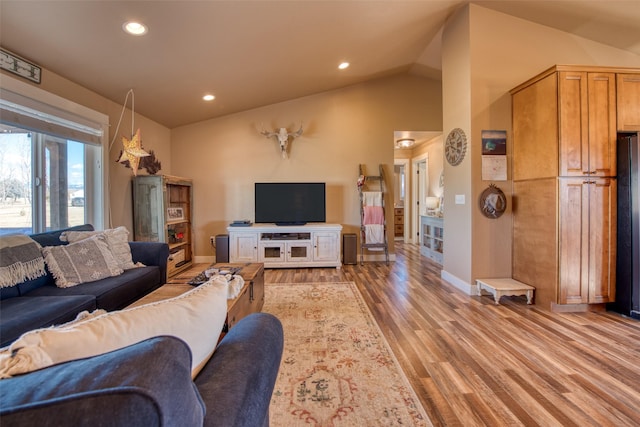 living room with recessed lighting, vaulted ceiling, light wood-style flooring, and baseboards