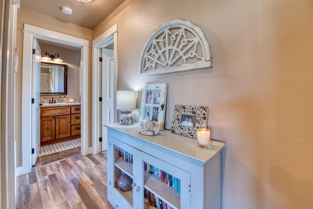 hall with a sink and light wood-style flooring