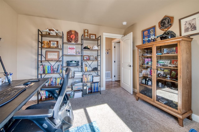 carpeted home office with baseboards and visible vents