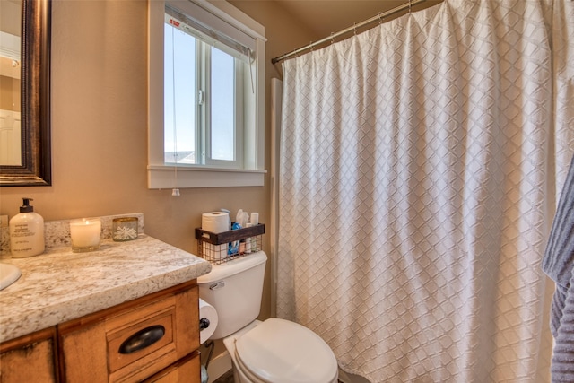 bathroom with toilet, a shower with shower curtain, and vanity