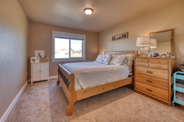 bedroom featuring baseboards and light colored carpet