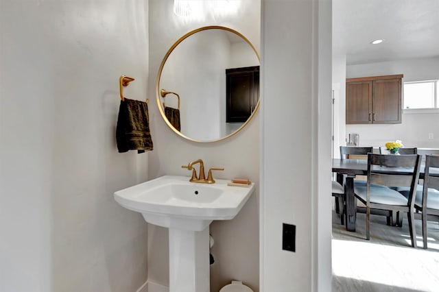 bathroom with a sink and recessed lighting