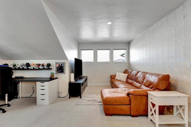 carpeted living area with baseboards and a textured ceiling