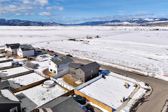 snowy aerial view with a mountain view