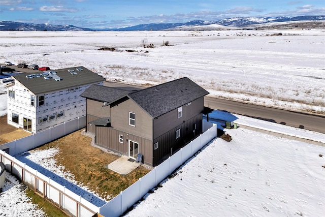 snowy aerial view featuring a mountain view