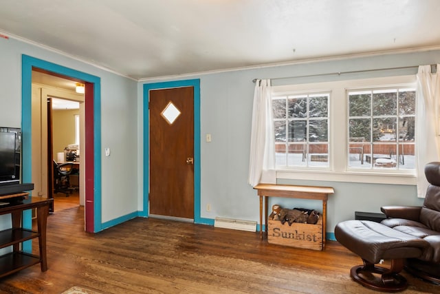 entryway featuring crown molding, wood finished floors, visible vents, and baseboards