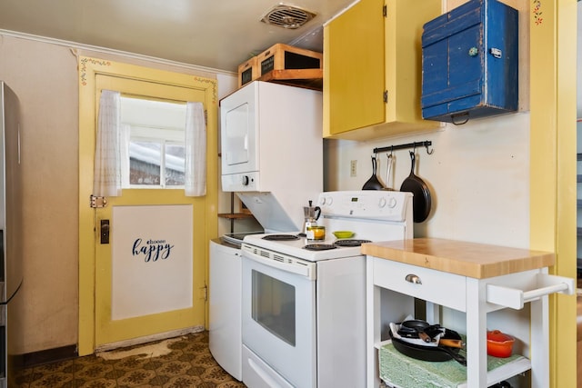 kitchen with dark floors, butcher block counters, white range with electric cooktop, and visible vents