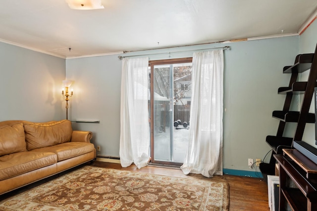 living room with baseboards, wood finished floors, and crown molding