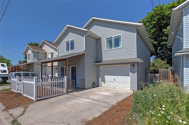 traditional-style house with a garage, fence, and concrete driveway